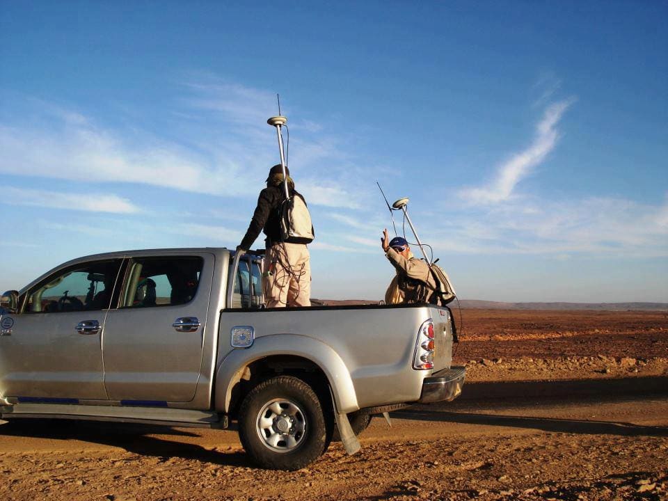 Surveyor with a total station on a road construction site